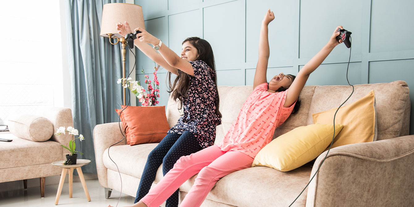 two young girls playing video games - are video games bad for kids