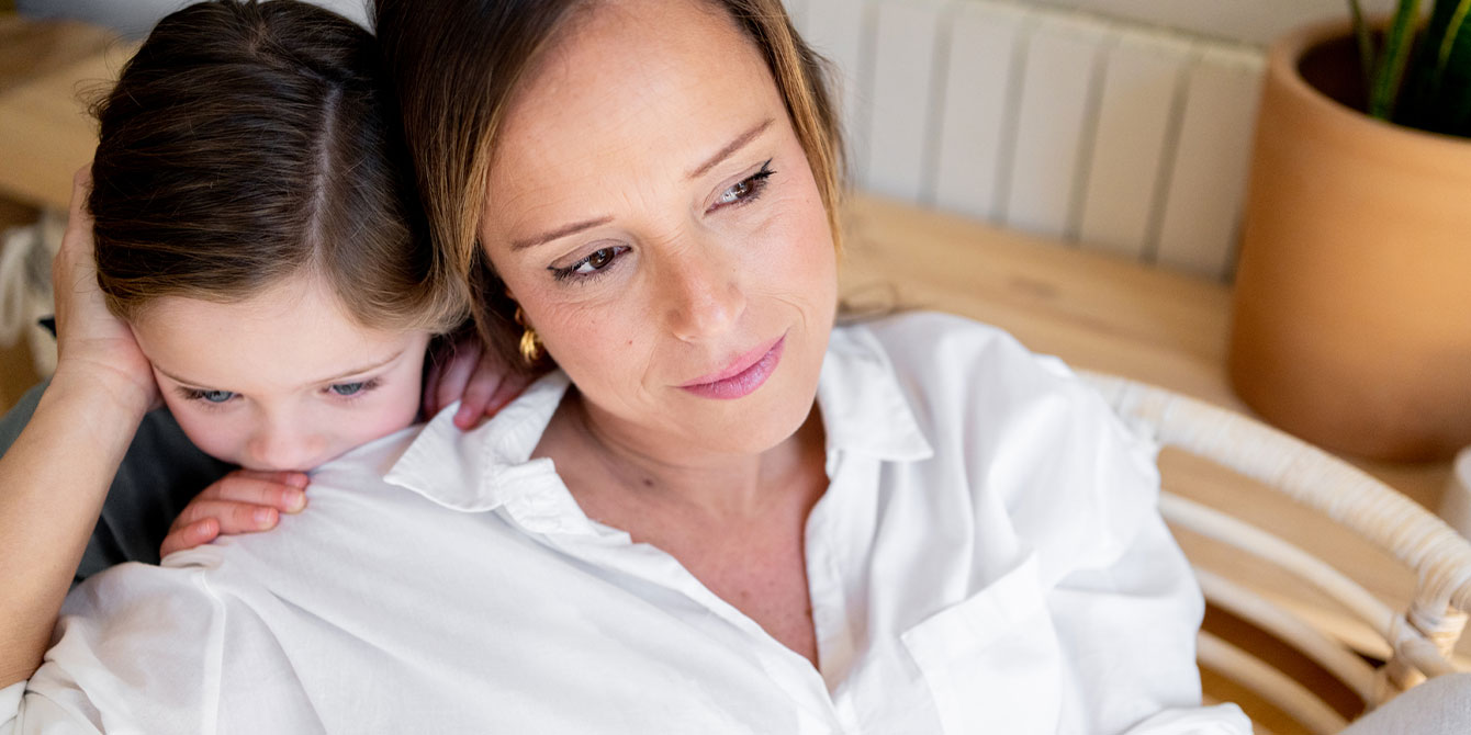 daughter hugging her mom from behind being a mom with depression