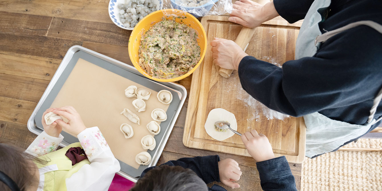 family making dumplings for Lunar New Year food