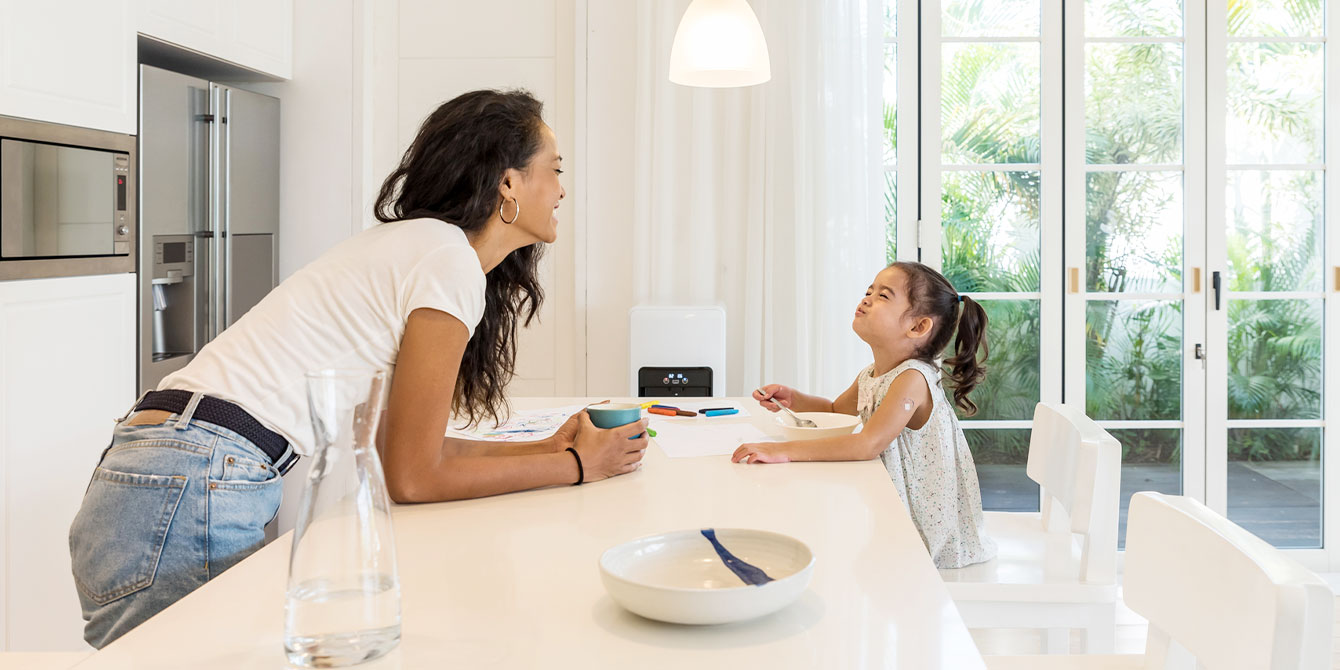 mom and daughter joking around in the kitchen showing what being a stay at home mom is like