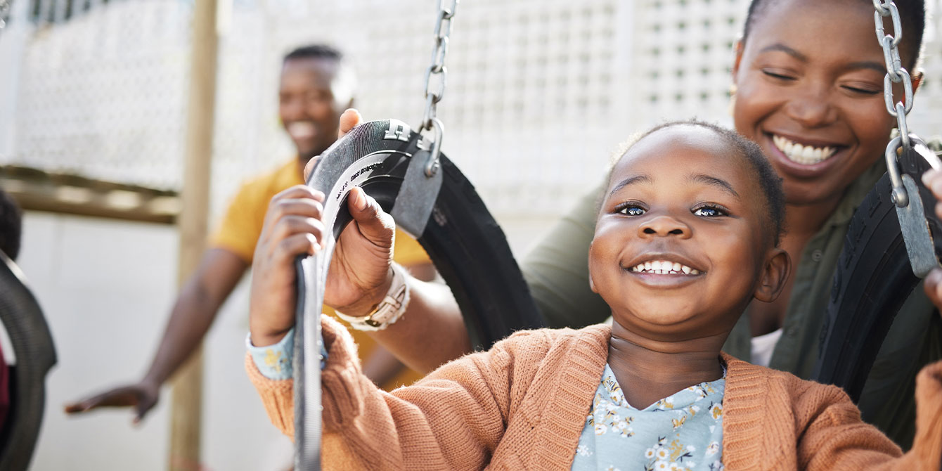 mom and young daughter playing on the swings - growing up is hard