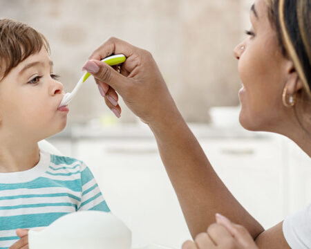 mom feeding toddler