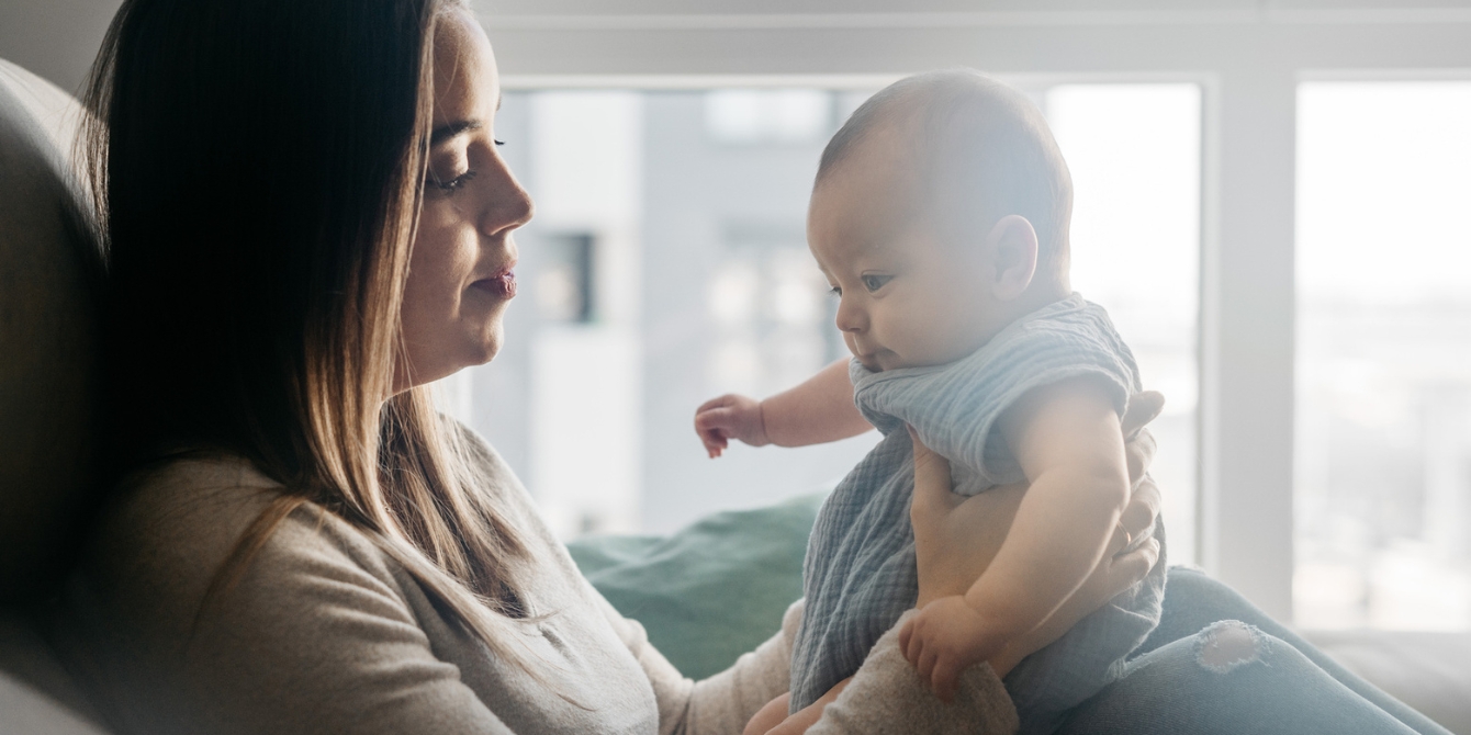 mom holding baby comparing yourself to others on social media