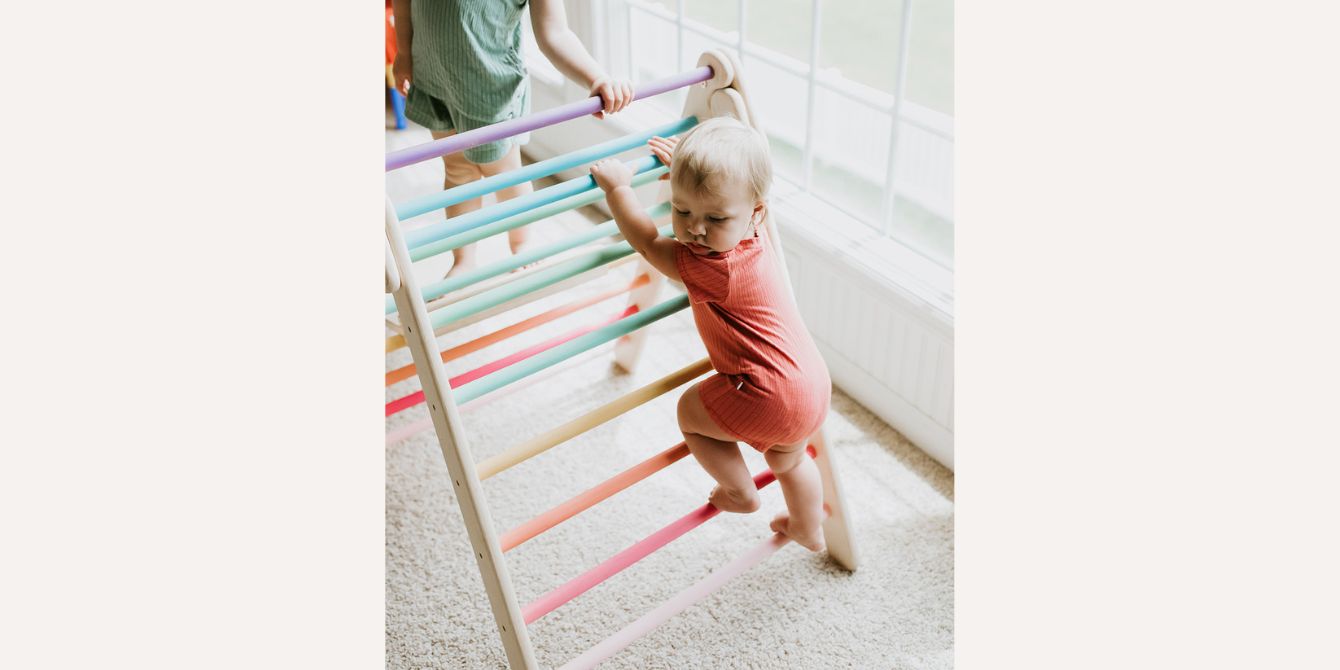 baby climbing on a Pikler triangle - Best Pikler triangles