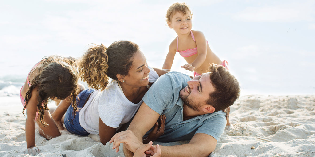 family enjoying vacation - reasons to travel with kids