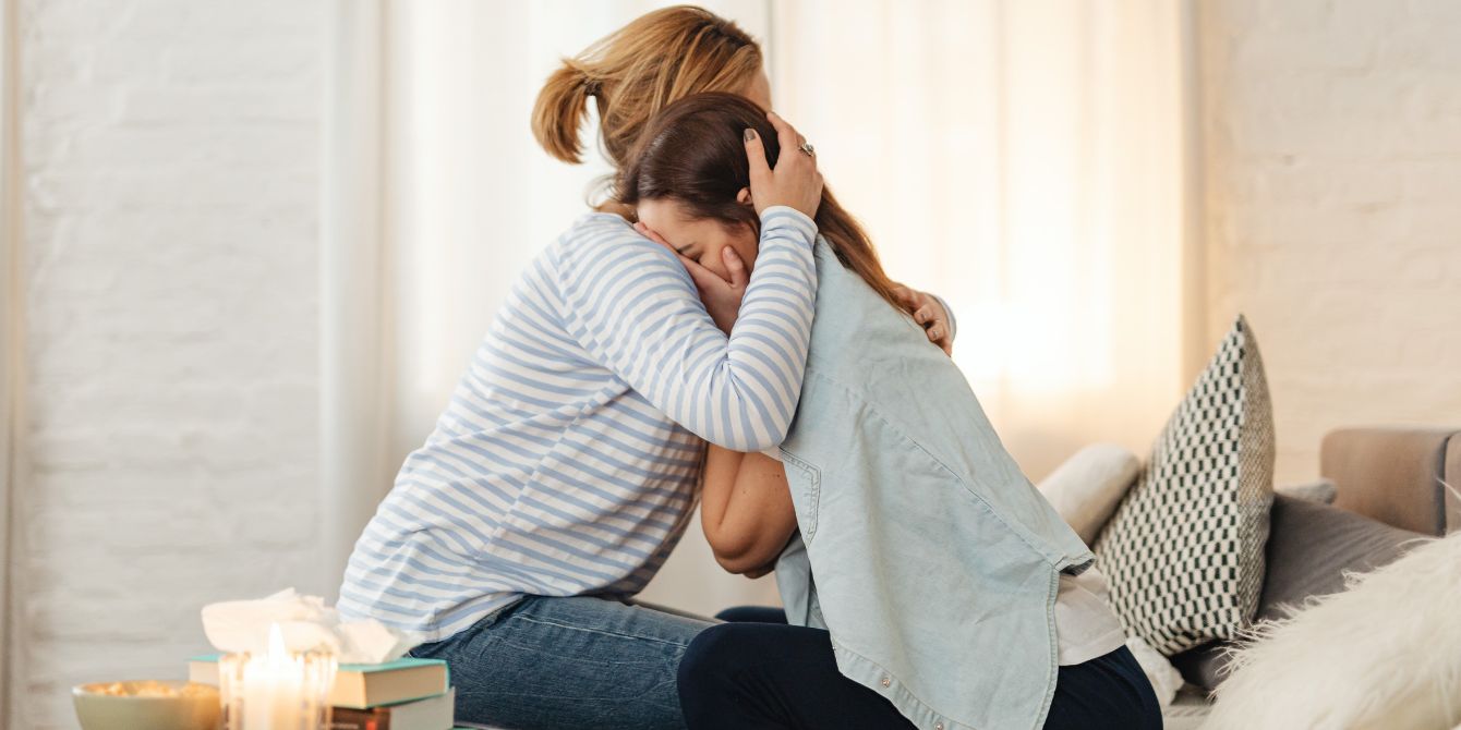 mom hugging teen daughter to support teen mental health