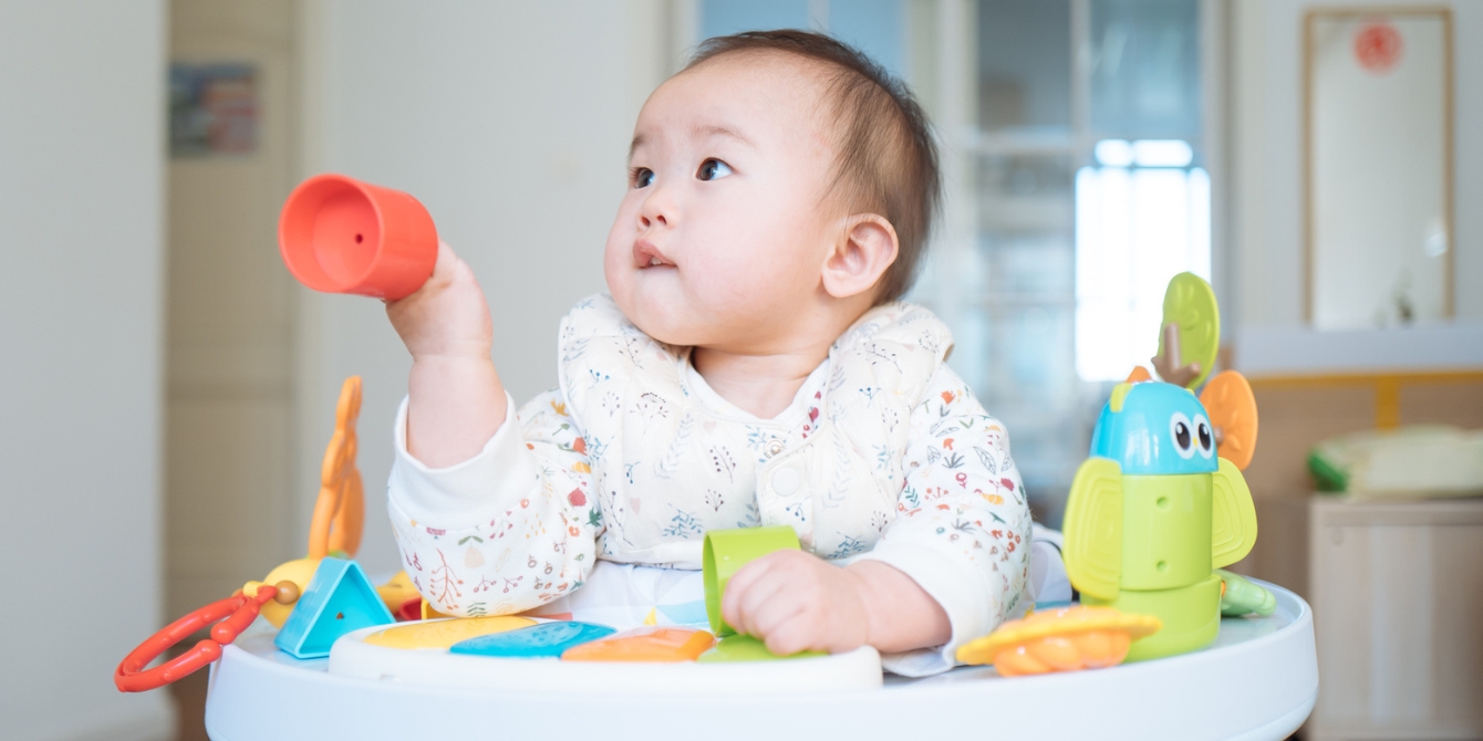 11-month-old baby playing at activity table - activities for 11-month-old