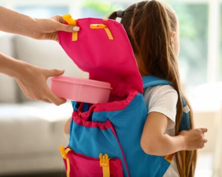 mom putting lunch box in childs backpack mom posts on aita about kids lunch