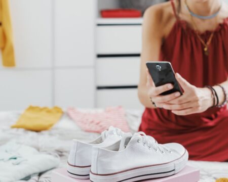 woman photographing to sell used clothes
