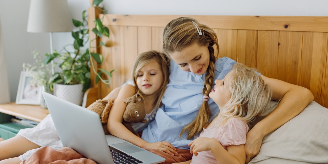 mom and two kids watching on laptop- movies to watch on mother's day