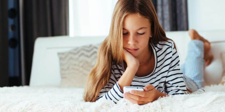 10 year old girl using social media smartphone Motherly