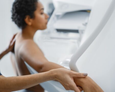 Female Doctor helping Mammogram Procedure Topless Latin Female Patient Motherly