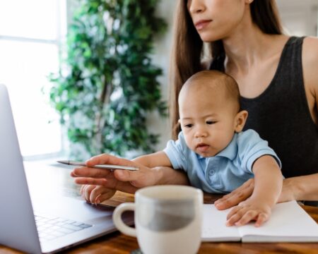 mother multi tasking with work and baby Motherly