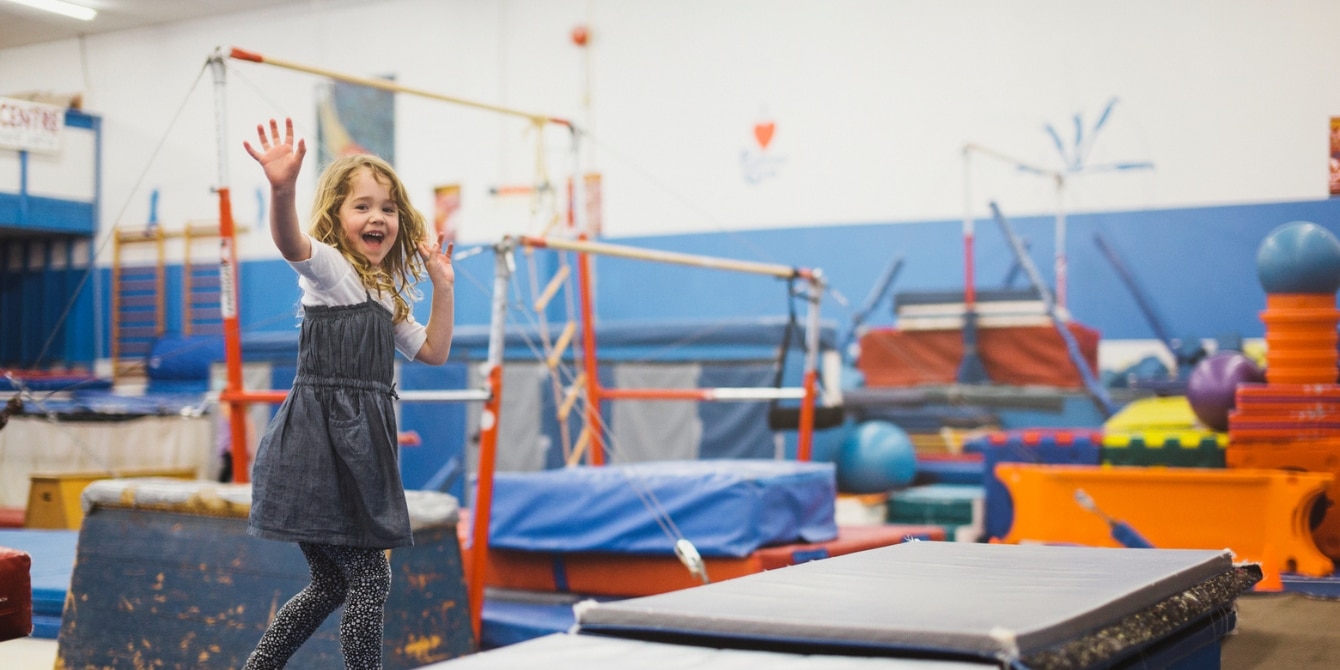 summer camp benefits for kids - girl playing at the little gym