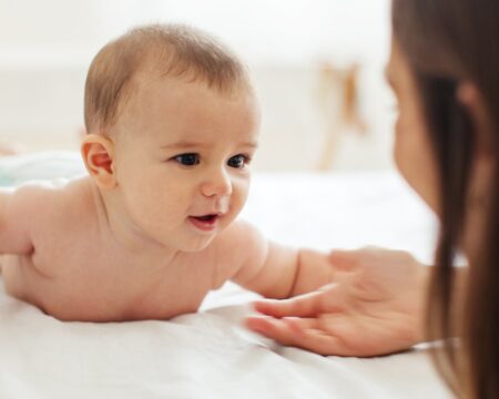 baby doing tummy time with mom 1 Motherly