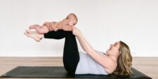 mom and baby doing yoga Motherly