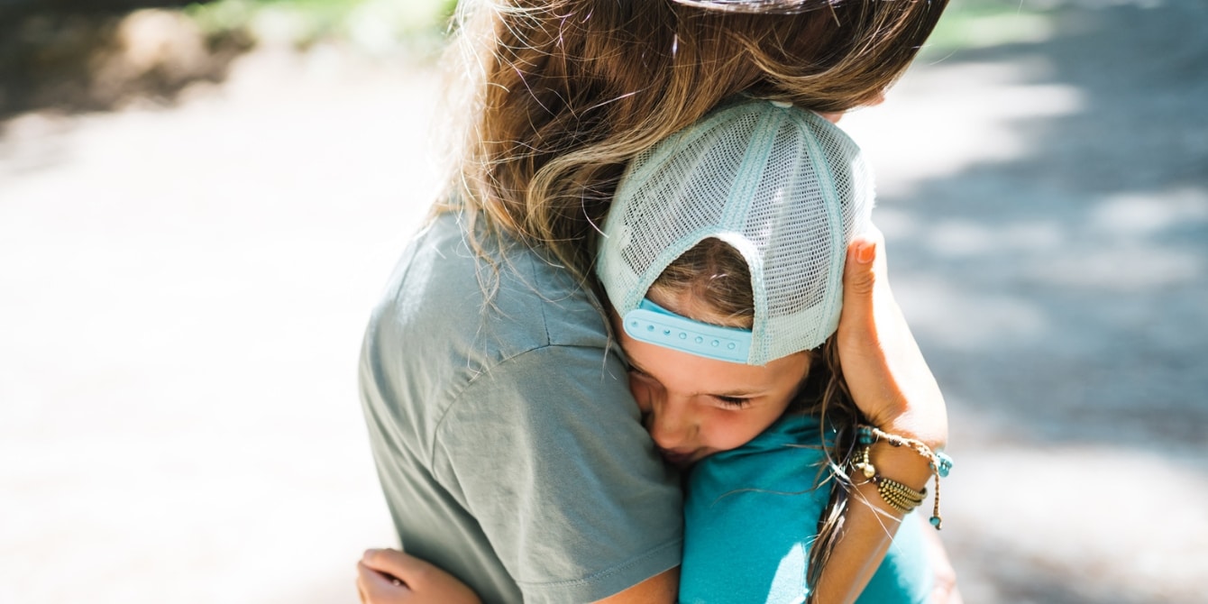 mom and daughter hugging outside - teach kids about hope