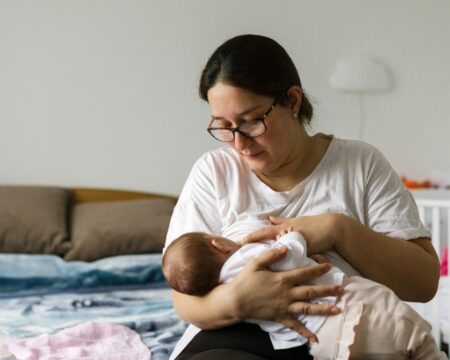 mom feeding newborn baby
