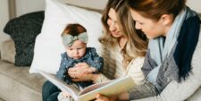 lesbian moms reading to baby Motherly