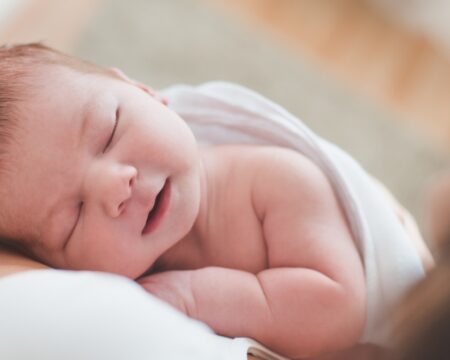 newborn baby sleeping on moms shoulder Motherly