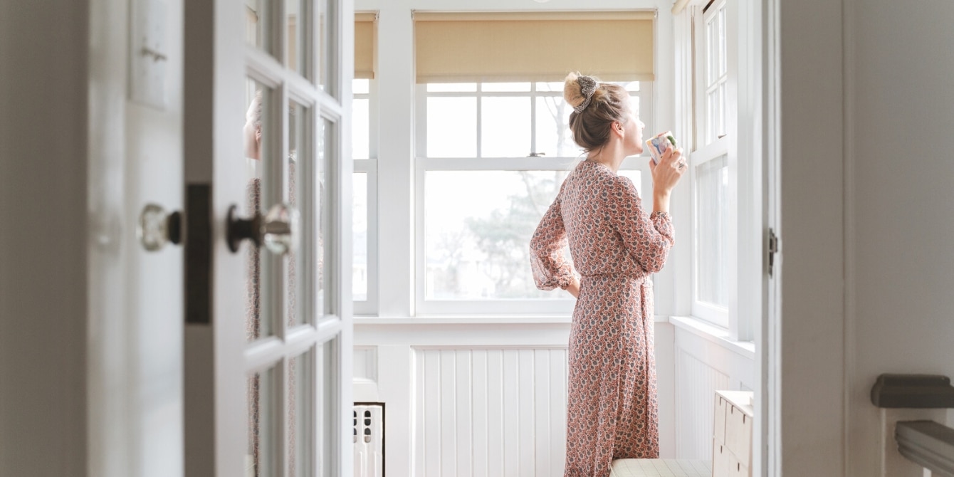woman looking outside the window- divorce grief