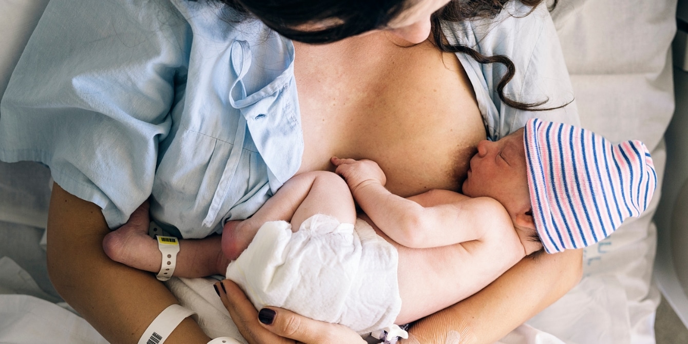 woman breastfeeding newborn baby in hospital - overcoming breastfeeding fears