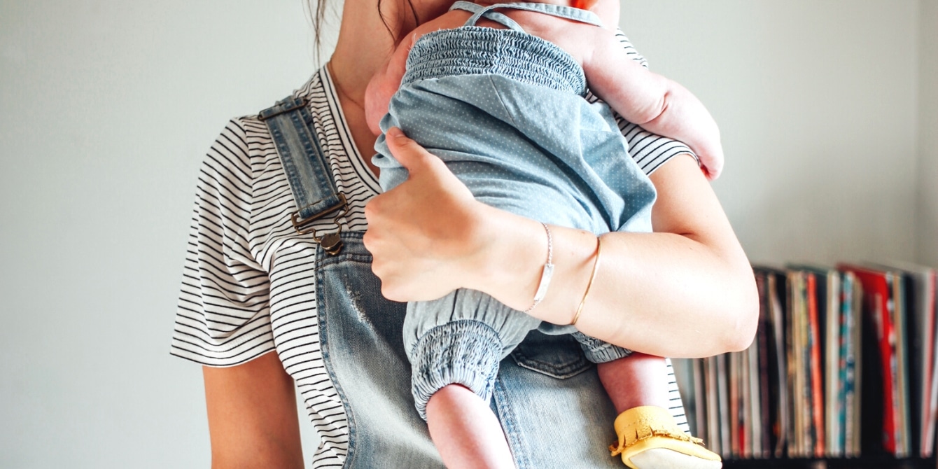 mother holding baby on her shoulder - being selfish as a parent