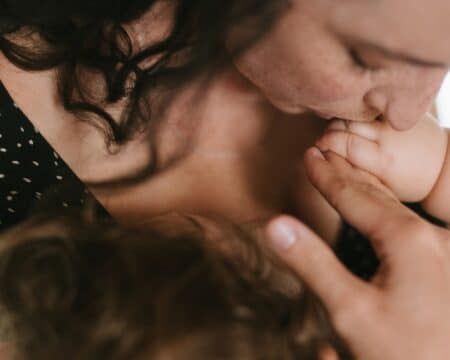 mother kissing baby hand Motherly