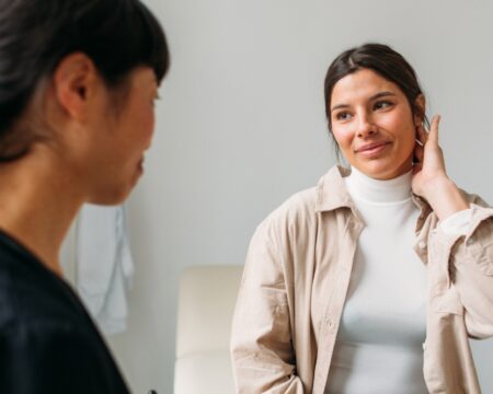 young woman at checkup with her doctor Motherly