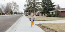 cute child running on neighborhood sidewalk Motherly