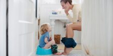 mother and son in bathroom on toilets same time Motherly