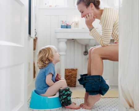 mother and son in bathroom on toilets same time Motherly