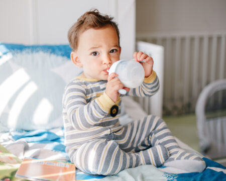 toddler boy drinking milk from sippy cup Motherly