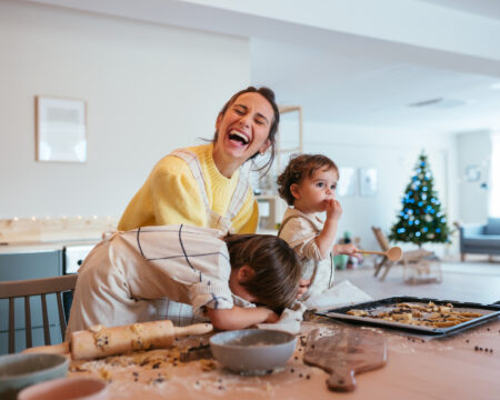 Mom and kids baking Christmas cookies at home