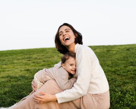 happy mom and toddler outside Motherly