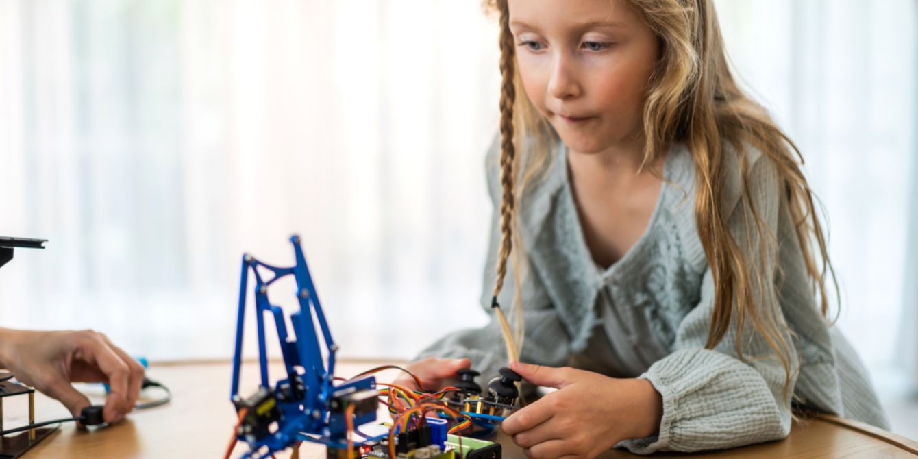 little girl playing with stem kit