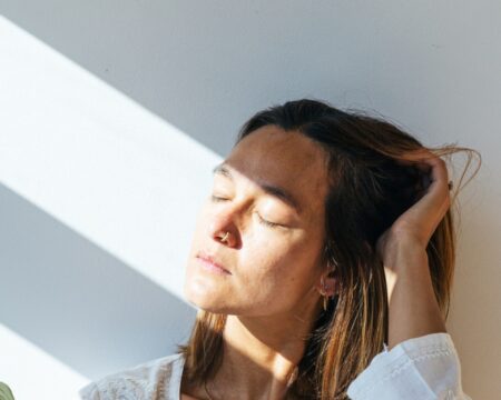 woman with sunlight shining on her face Motherly