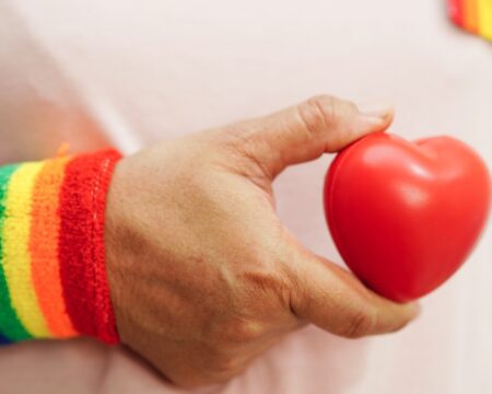 person holding rainbow heart Motherly