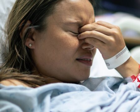 sad woman in hospital bed Motherly