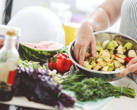 woman in kitchen cooking vegetables Motherly