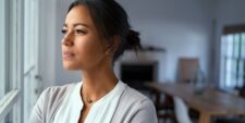 woman looking out window Motherly