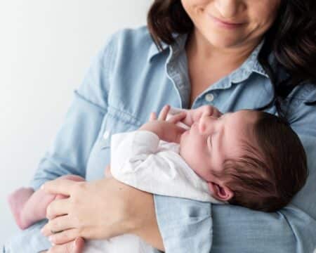 a mother looking down at her baby Motherly