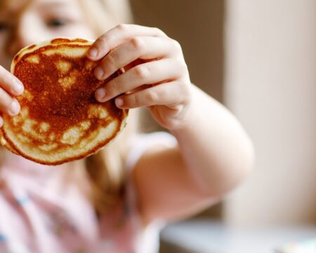 preschool girl holding pancake Motherly