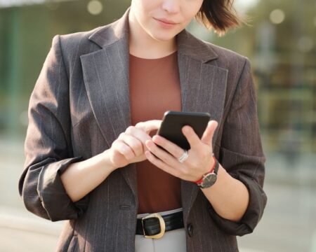 woman checking phone selecting your sperm donor Motherly