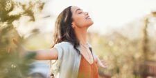 woman outside closing eyes peaceful Motherly