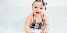 baby girl wearing bow smiling baby girl names Motherly