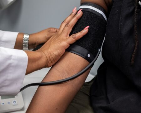 black woman having blood pressure taken Motherly