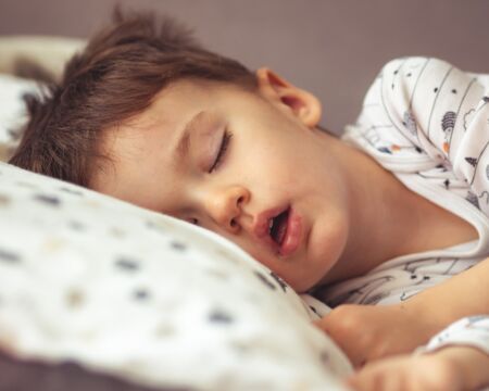 child in bed sleeping with mouth open Motherly