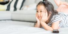 cute little girl watching tv Motherly