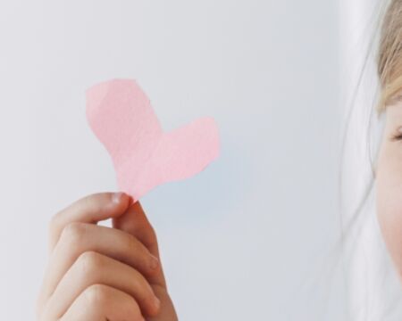 little girl holding paper heart Motherly